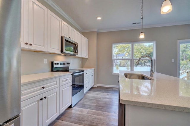 kitchen featuring light stone countertops, sink, stainless steel appliances, pendant lighting, and white cabinets