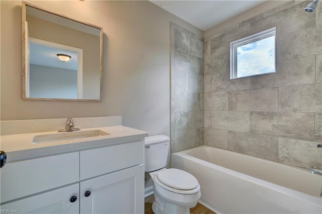 full bathroom with toilet, vanity, and tiled shower / bath combo