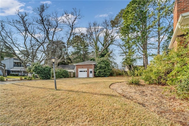 view of yard featuring a garage and an outdoor structure