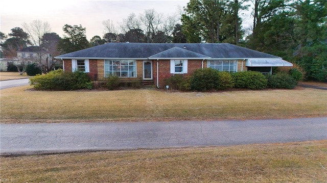 ranch-style home with a front yard