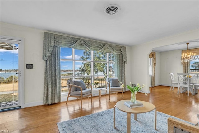 living area featuring hardwood / wood-style flooring and a notable chandelier