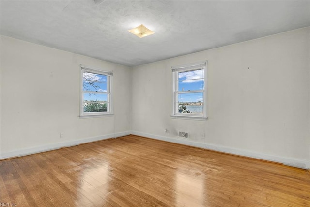 empty room with light hardwood / wood-style flooring