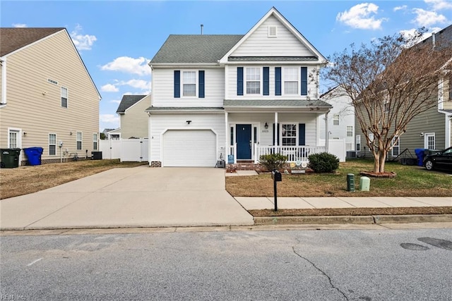 front of property with a front yard, a porch, and a garage