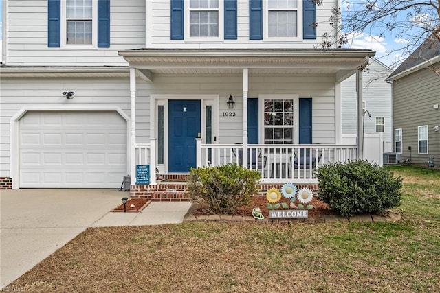 property entrance with covered porch, a yard, and a garage