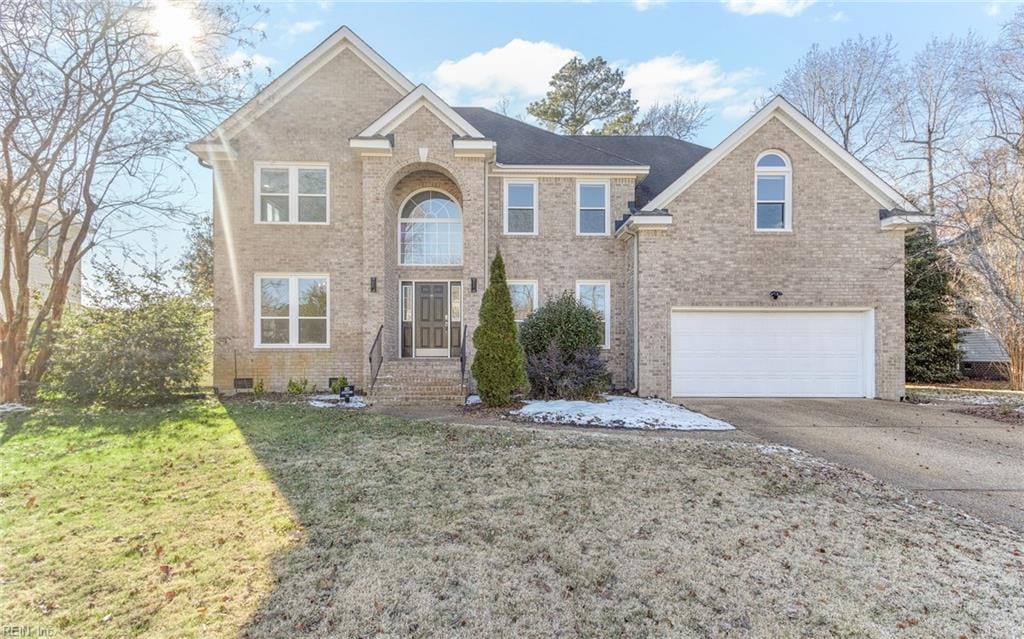 view of front of property with a front lawn and a garage