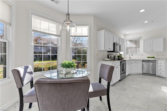 tiled dining space featuring plenty of natural light