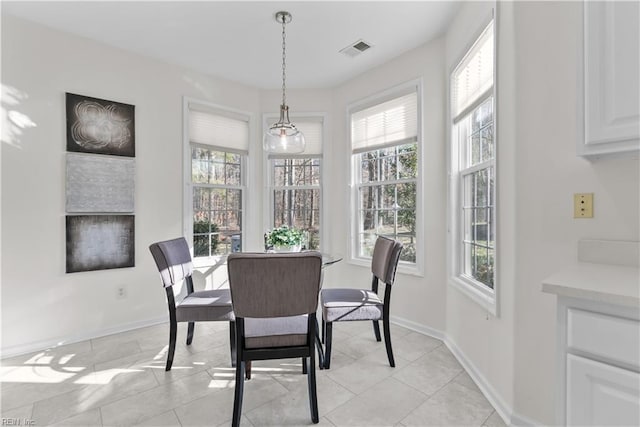 dining space featuring light tile patterned floors