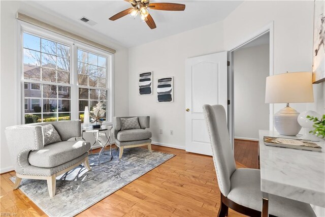 office with ceiling fan and light hardwood / wood-style flooring