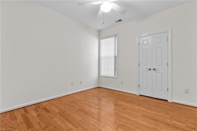 spare room with light hardwood / wood-style flooring and ceiling fan