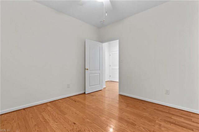 spare room with light hardwood / wood-style flooring and ceiling fan