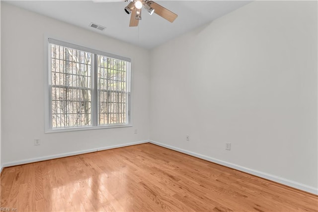 empty room with ceiling fan and light wood-type flooring