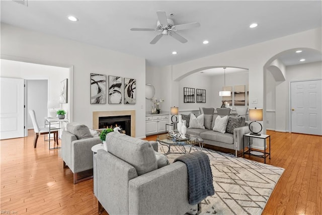 living room featuring ceiling fan and light hardwood / wood-style floors