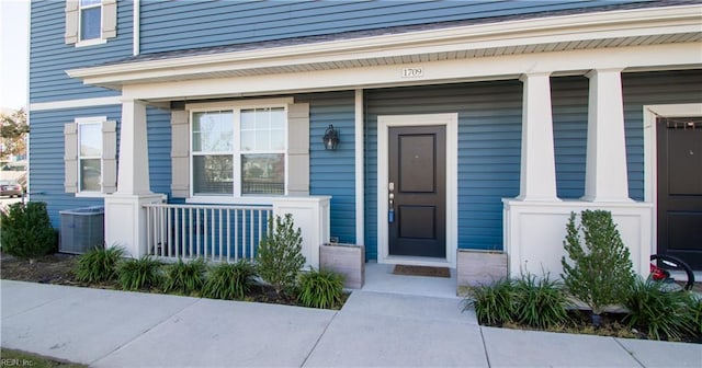 property entrance with covered porch and cooling unit