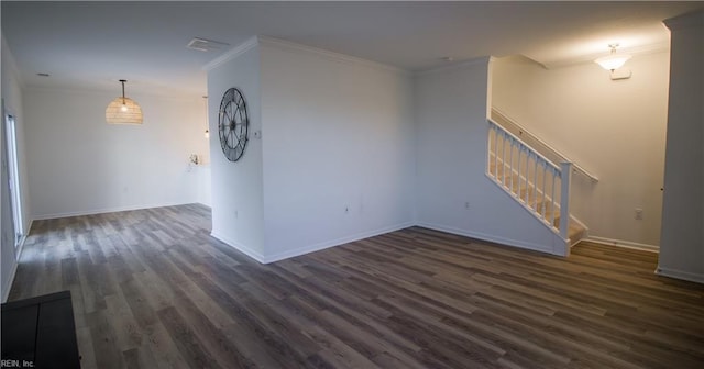 empty room featuring dark hardwood / wood-style floors and ornamental molding