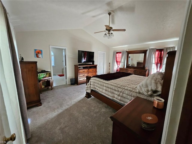 bedroom with carpet floors, ceiling fan, lofted ceiling, and connected bathroom