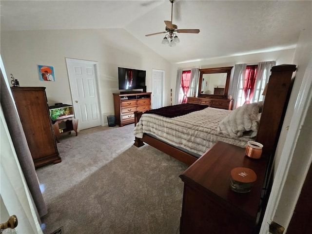 carpeted bedroom with ceiling fan and vaulted ceiling