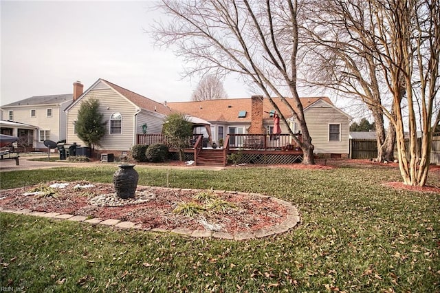 exterior space with a front lawn and a wooden deck