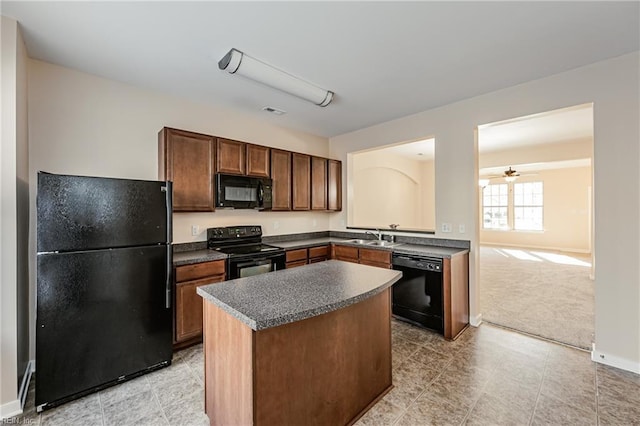 kitchen featuring a center island, light carpet, black appliances, sink, and ceiling fan