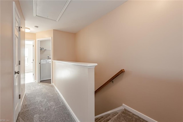 corridor featuring light carpet and washer / dryer