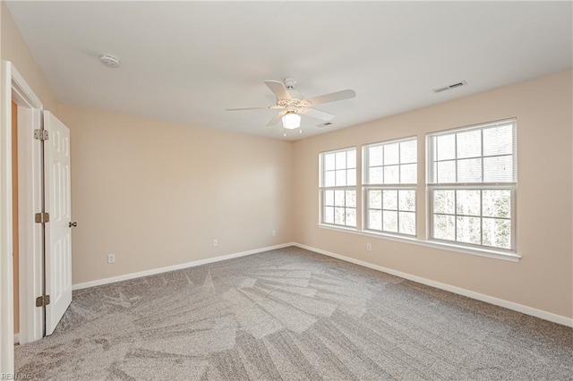 carpeted empty room with ceiling fan