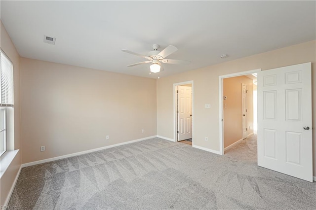 unfurnished bedroom with ceiling fan and light colored carpet