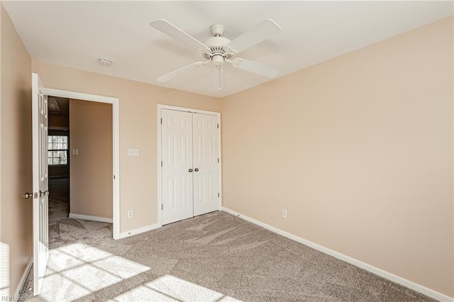 unfurnished bedroom with ceiling fan, light carpet, and a closet