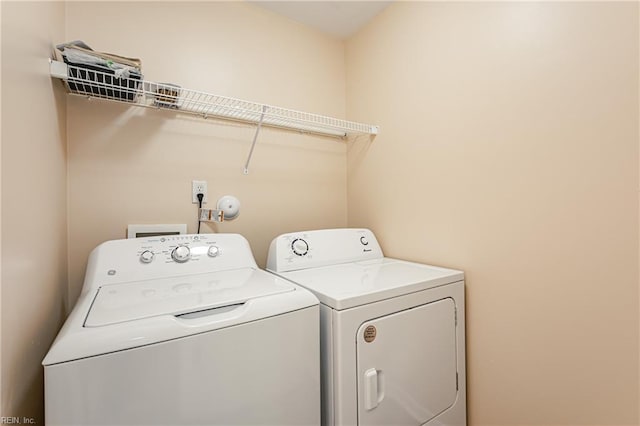 washroom featuring independent washer and dryer