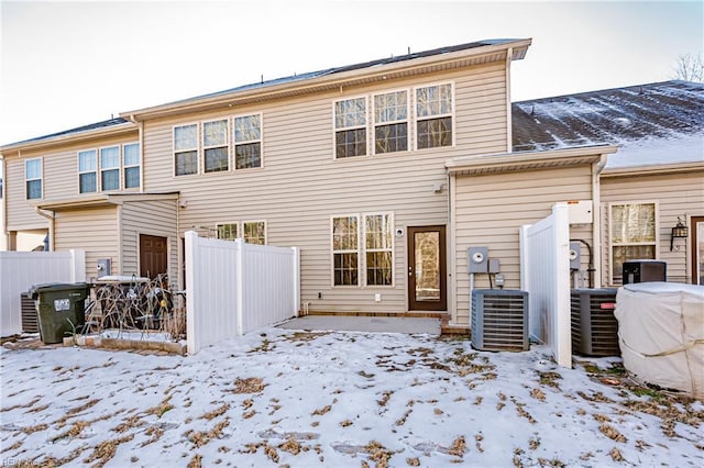 snow covered property featuring central air condition unit