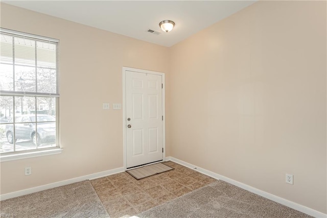 doorway to outside with light colored carpet