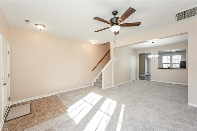 spare room with light colored carpet and ceiling fan with notable chandelier