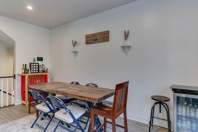 dining area featuring wood-type flooring and wine cooler