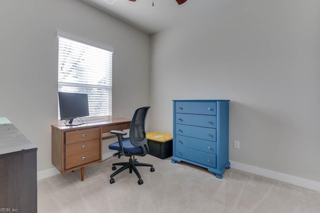 carpeted home office with ceiling fan