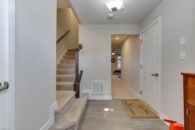 foyer with wood-type flooring and ceiling fan