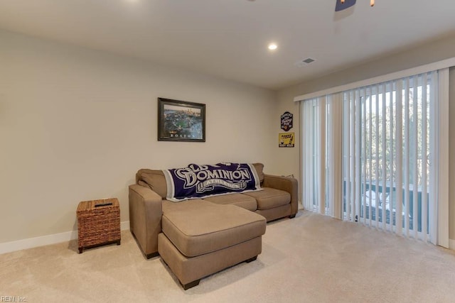 carpeted living room featuring ceiling fan