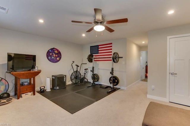 workout room featuring ceiling fan and light colored carpet