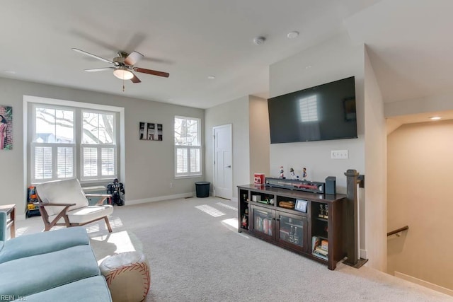 carpeted living room with ceiling fan