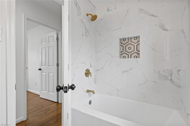 bathroom featuring hardwood / wood-style flooring and tiled shower / bath combo