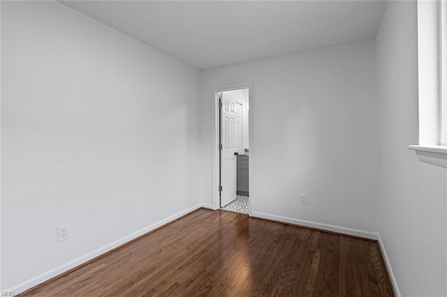 empty room with dark hardwood / wood-style floors