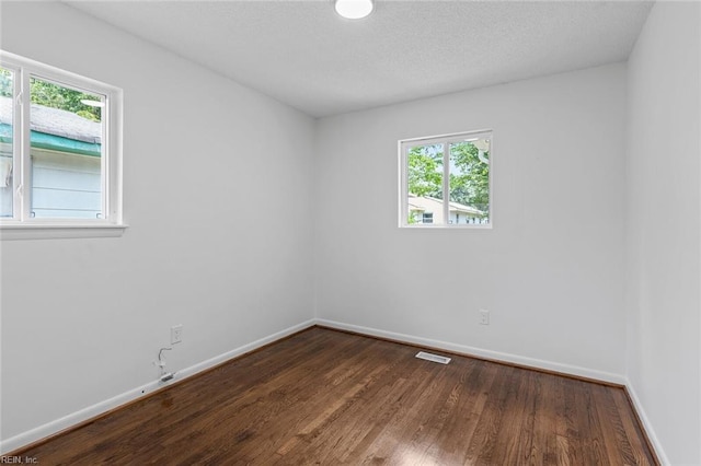 unfurnished room featuring dark wood-type flooring