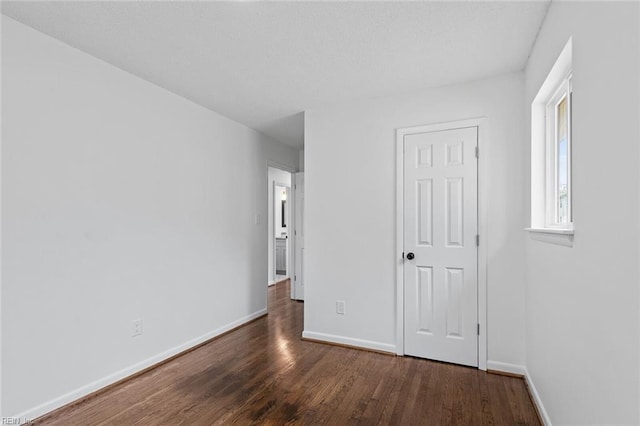 unfurnished bedroom featuring dark hardwood / wood-style flooring