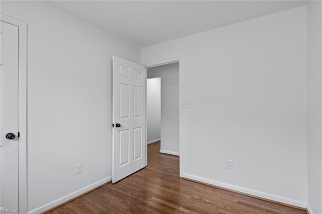 unfurnished bedroom featuring dark hardwood / wood-style floors