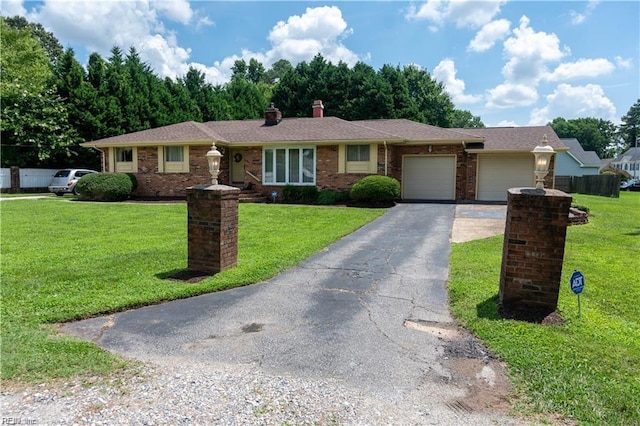 ranch-style house featuring a garage and a front lawn