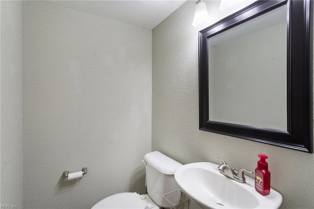 bathroom featuring sink and toilet