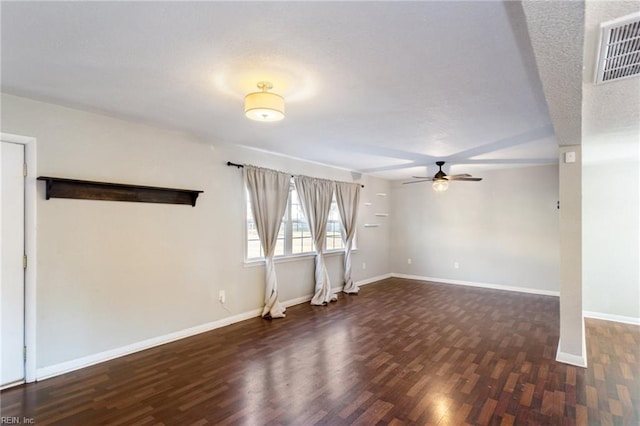 unfurnished room with ceiling fan and dark wood-type flooring