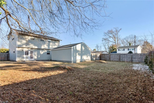 rear view of property featuring a lawn