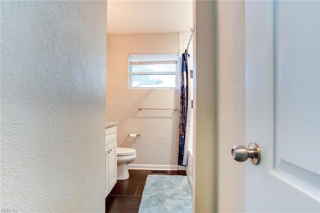 full bathroom with toilet, vanity, and shower / tub combo with curtain