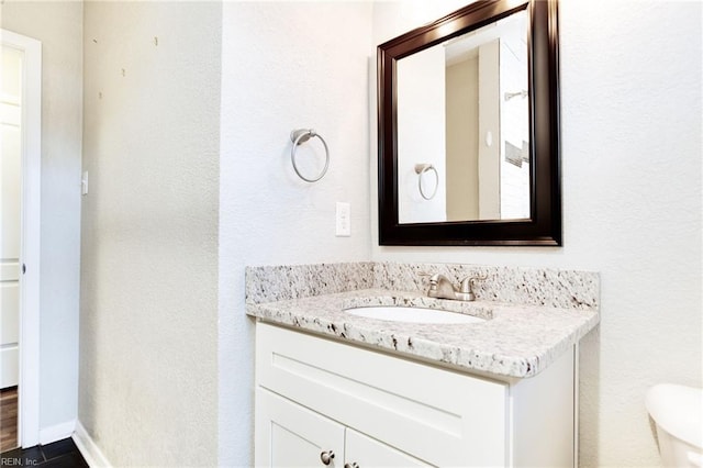 bathroom featuring toilet and vanity