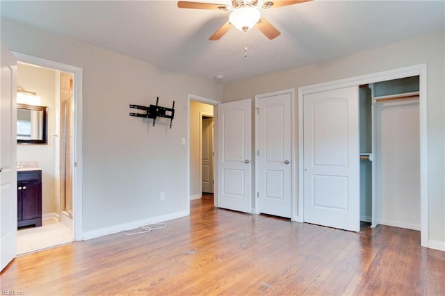 unfurnished bedroom featuring ceiling fan, connected bathroom, and light hardwood / wood-style flooring