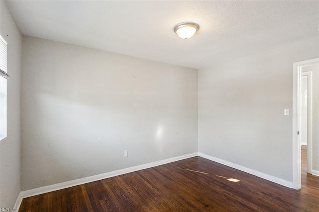 empty room with dark hardwood / wood-style floors