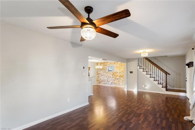 unfurnished living room featuring dark wood-type flooring and ceiling fan